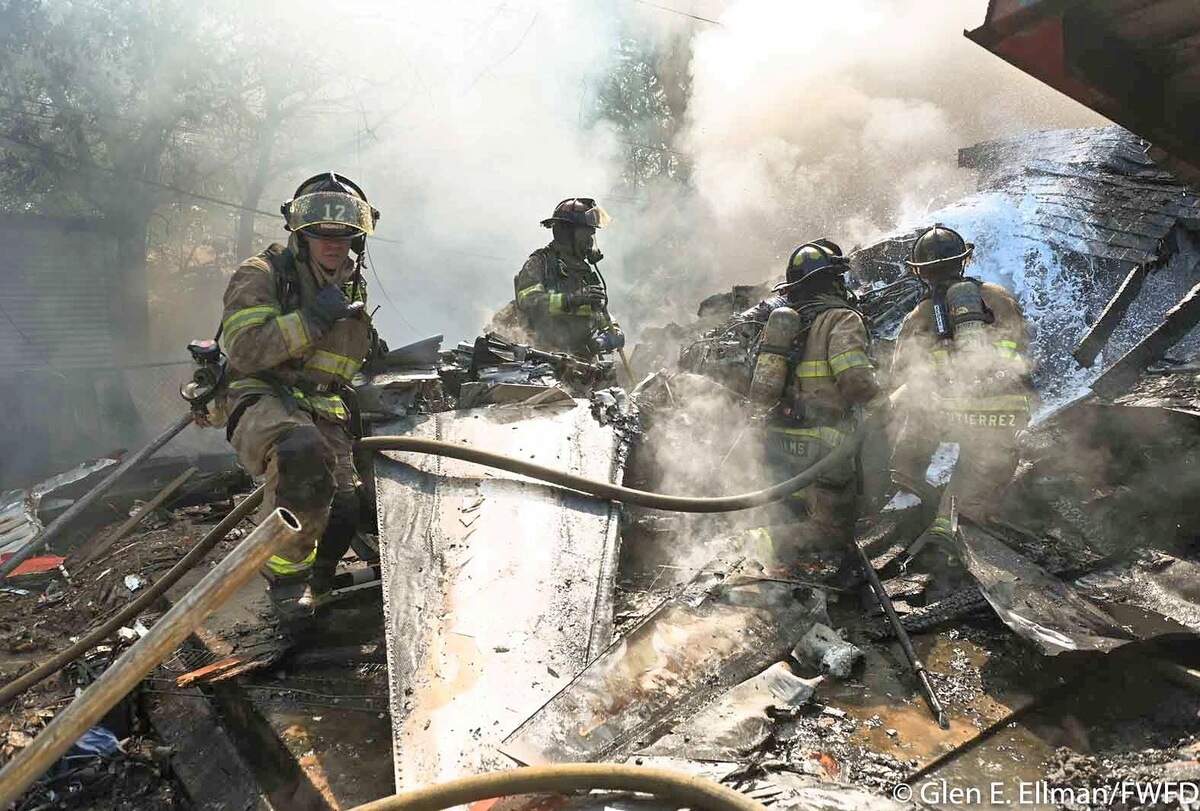 Three homes were damaged when a military plane crashed in a Lake Worth, Texas, neighborhood on Sunday, Sept. 19, 2021. Residents and local authorities say it’s a miracle no one was killed.
