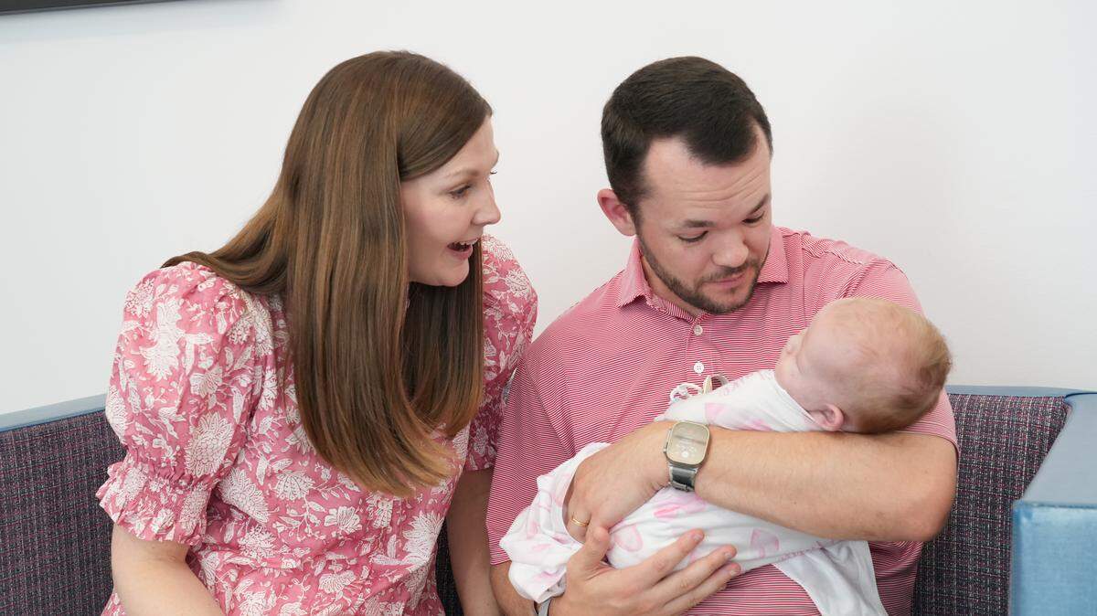 Sarah Ellen and Zach Beavers with their daughter Anna Claire, who was born with two conditions that made survival without a high-risk surgery unlikely.