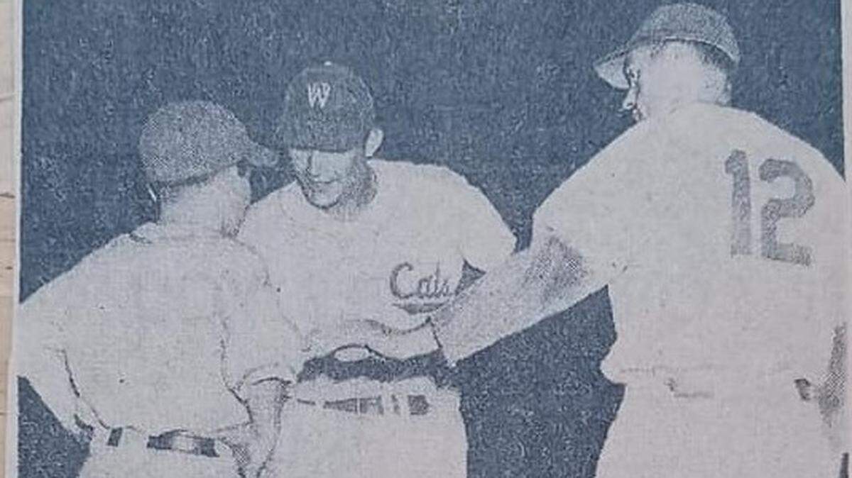Bat boy Rudy Herrera, shown on the left in this Star-Telegram newspaper clipping, translates for Chico Carrasquel, center.