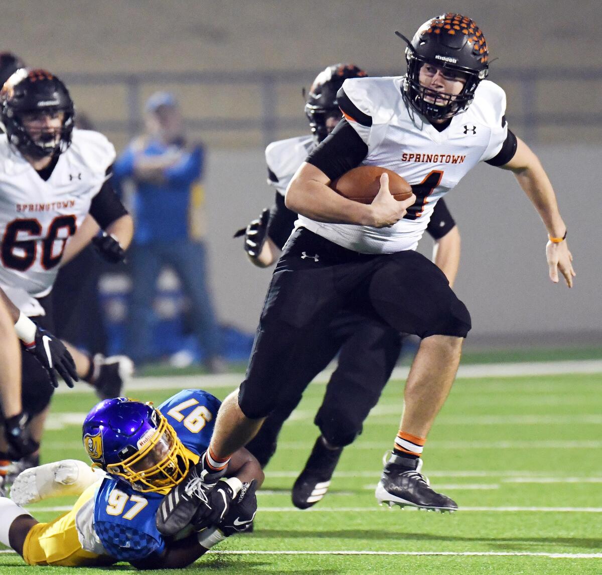Springtown quarterback Camden Chesney, right is tripped up by LaVega’s De’Trevon Thompson as he scrambles out of the backfiel in the first quarterof their Class 4A Division1 semifinal football game Friday, December 13, 2019 at the Midlothain Multpurpose Stadium in Midlothian, Texas. Special/Bob Haynes
