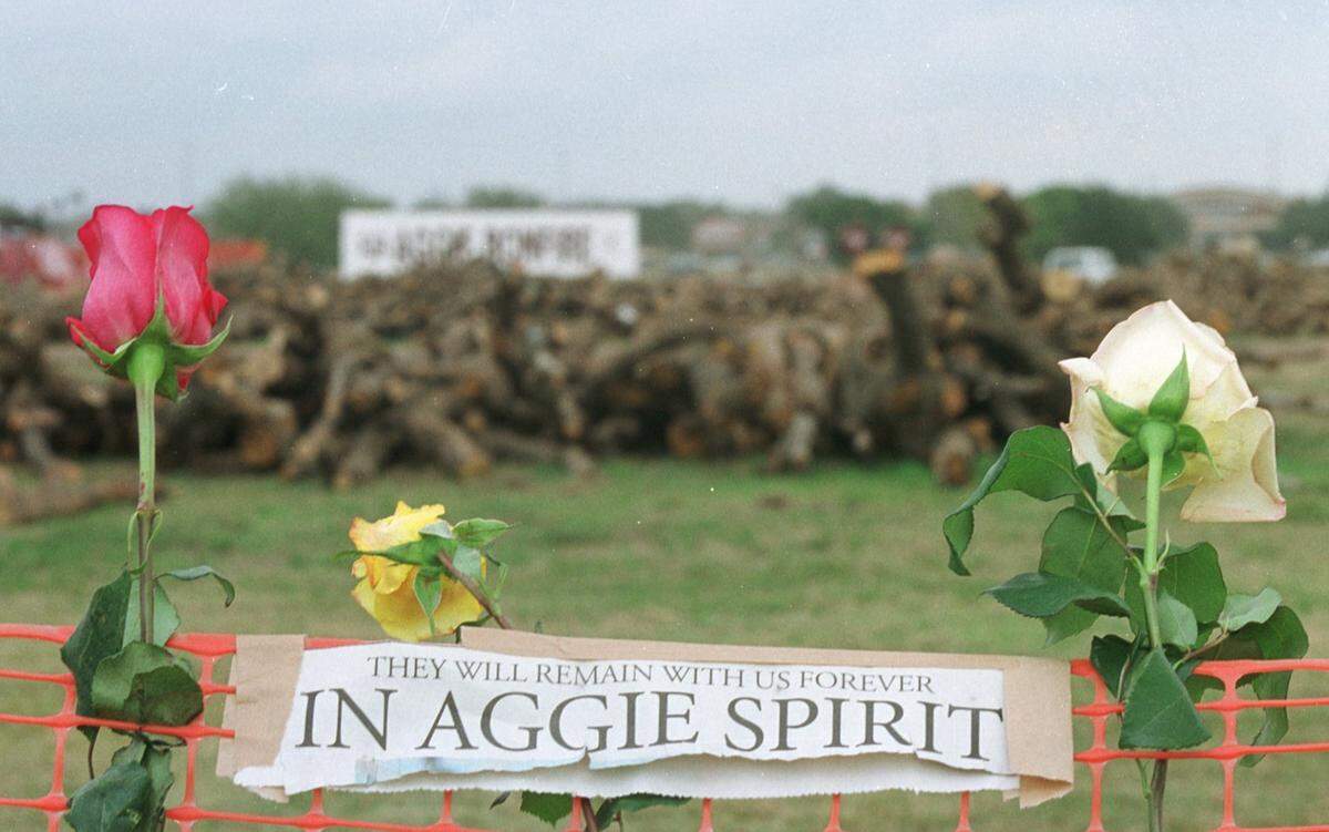 Mourners placed flowers, signs and memorabilia around the tragic scene where 12 students were killed in the collapsed bonfire at Texas A&M on Nov. 18, 1999.