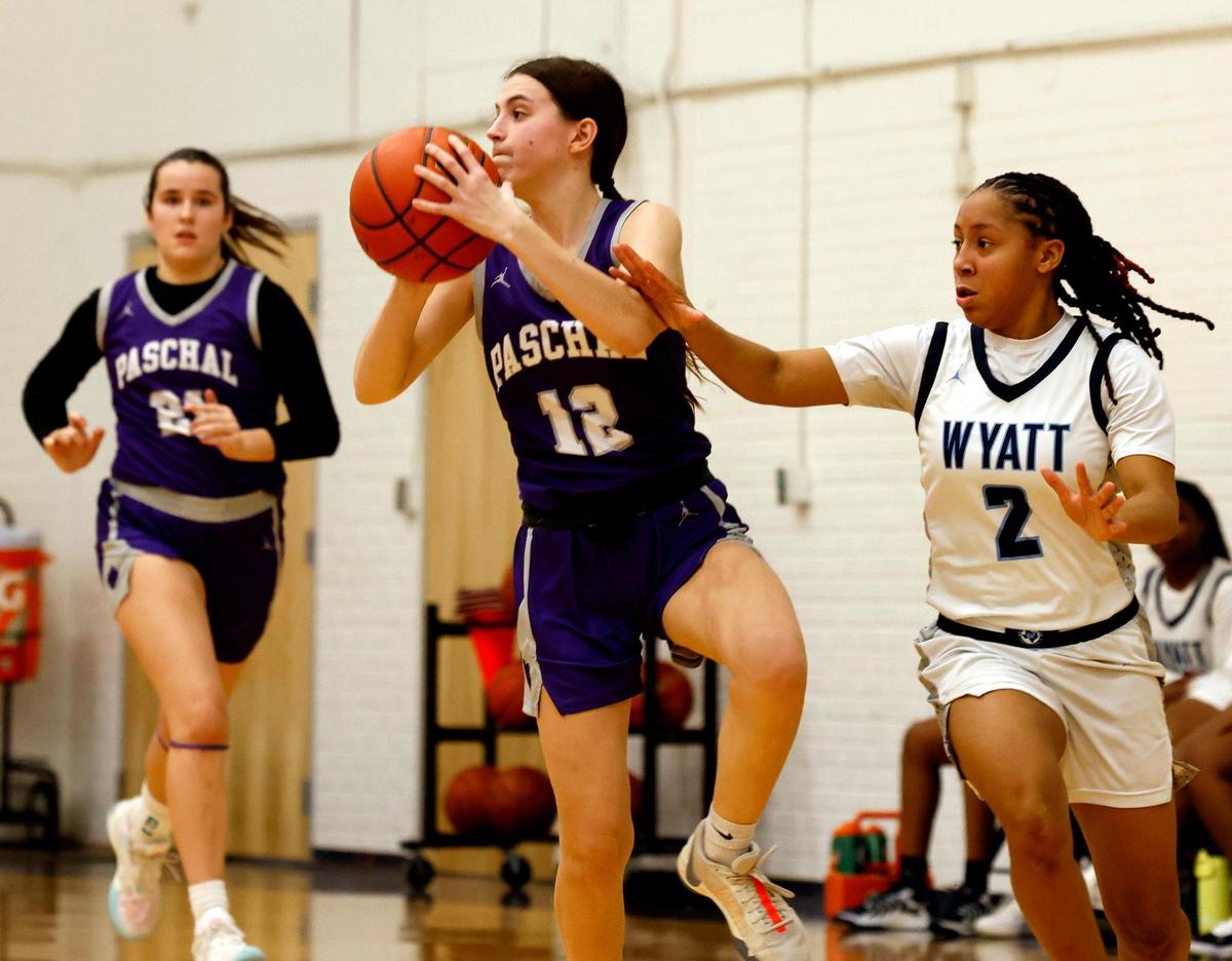 Paschal point guard Adeline Stults (12) passes across court in front of O.D. Wyatt guard Jordyn Lee Mathis (2) during a UIL girls basketball game at O.D. Wyatt High School in Fort Worth, Texas, Friday, Jan. 24, 2025.
