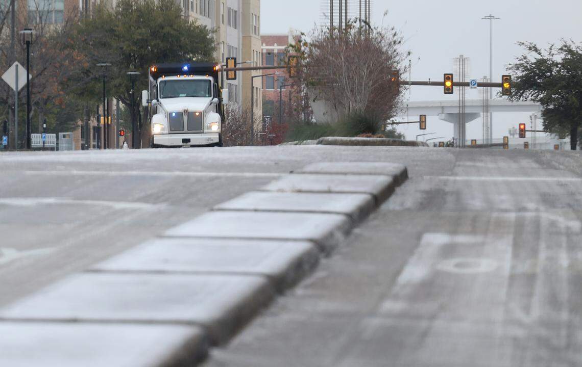 A thin layer of sleet covers East Lancaster Avenue on South Main Street on Saturday morning, Jan. 24, 2026. Road conditions are expected to deteriorate as massive Arctic cold front moves across North Texas this weekend.