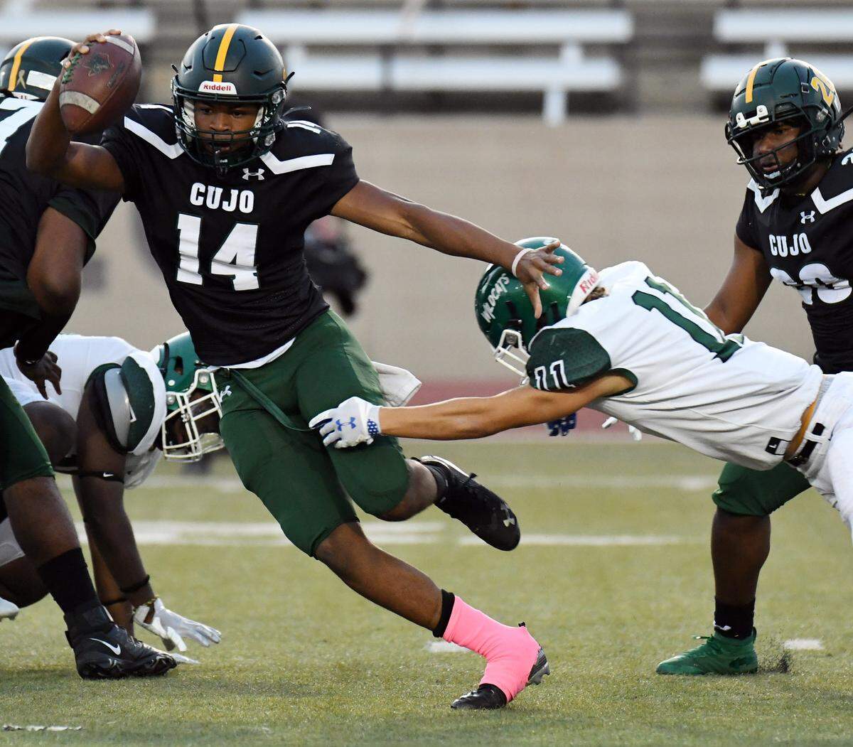 Western Hills quarterback Keyon Butler tries to escape the grasp of Kennedale’s Shane Hull as he scrambles out of the backfield in the first quarter of their District 6-4A Division 1 football game at Farrington Field in Fort Worth, Texas. Special/Bob Haynes