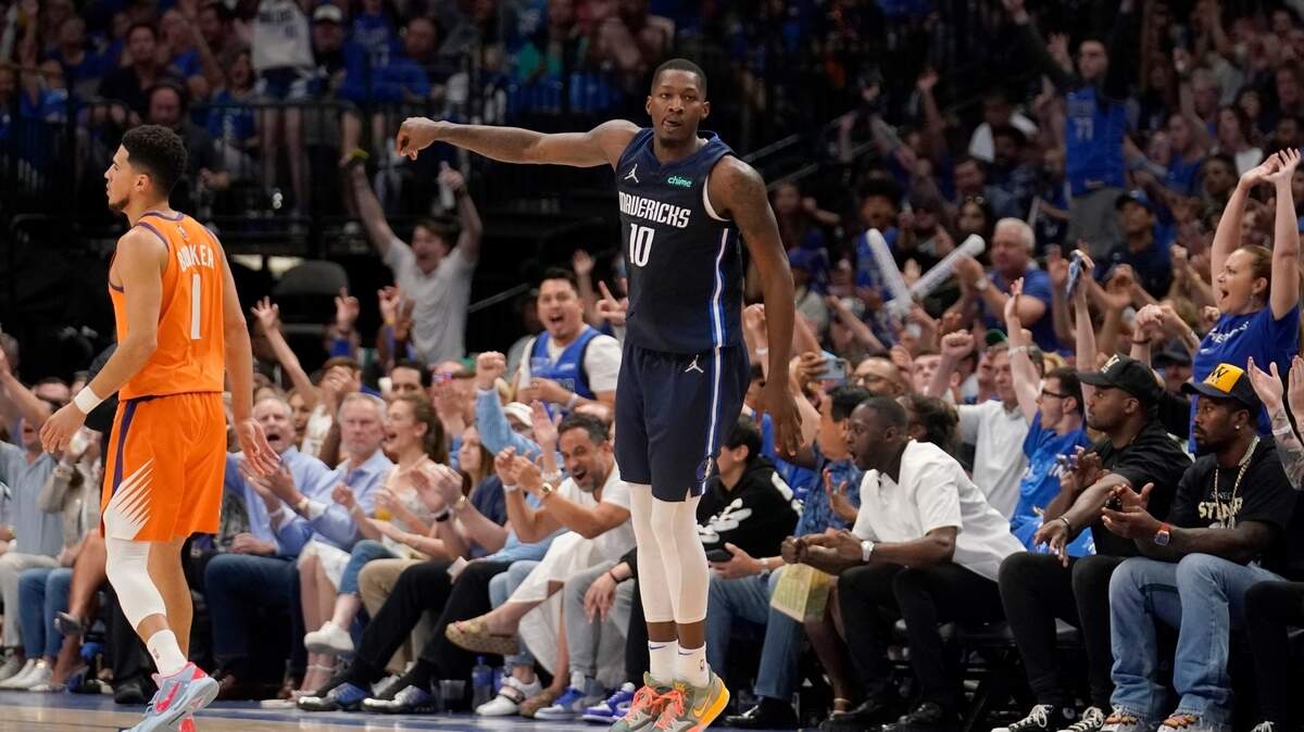 Dallas Mavericks forward Dorian Finney-Smith celebrates one of his eight 3-pointers in Sunday’s victory over the Phoenix Suns and guard Devin Booker. Finney-Smith finished with 24 points as the Mavs evened the playoff series 2-2.