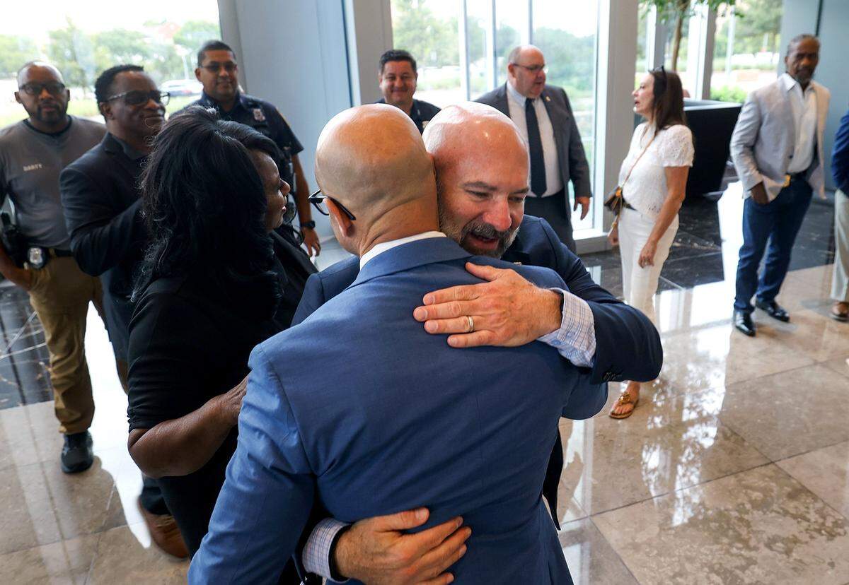 Neil Noakes, former Fort Worth police chief, hugs Eddie Garcia prior to a press conference on Friday, Aug. 22, 2025, at City Hall. Garcia was announced as the next Fort Worth police chief.