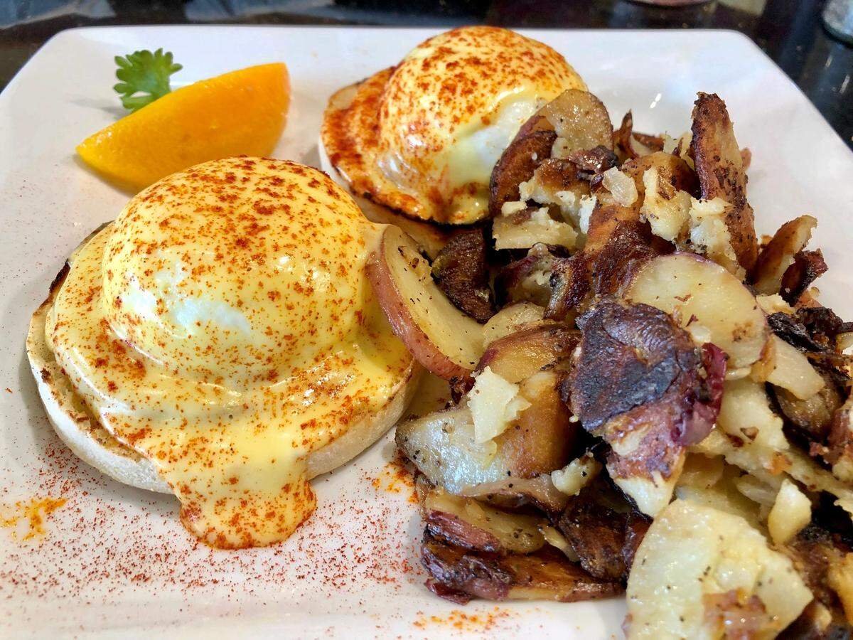 Traditional eggs Benedict with home fries from Keke’s Breakfast Cafe.