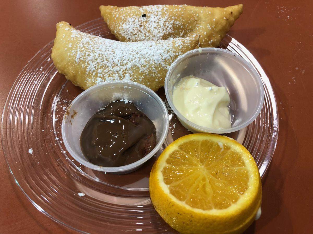 Fernie’s Orange You Glad We Made It: fried turnovers stuffed with orange custard, dusted with powdered sugar and served with sauces.