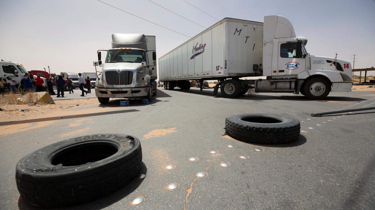 Truckers block the entrance into the Santa Teresa Port of Entry in Ciudad Juarez going into New Mexico on April 12, 2022. The truckers blocked the port as a protest to the prolonged processing times implemented by Gov. Abbott which they say have increased from 2-3 hours up to 14 hours in the last few days. (Omar Ornelas /The El Paso Times via AP)