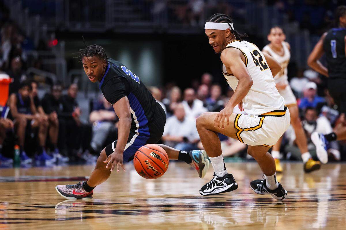 North Crowley guard Kameron Price (2) looks toward a loose ball and starts his diving attempt to recover it as a San Antonio Brennan defender goes for the ball in the Class 6A Division I state championship at The Alamodome in San Antonio, Texas, March 14, 2026.
