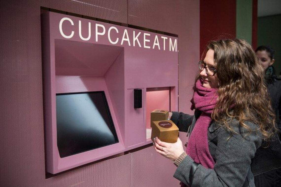 The Cupcake ATM opened today, and while there were certain technical difficulties for the first day, lines of people waited to try out the new machine. (Photo by Andrew Burton/Getty Images)