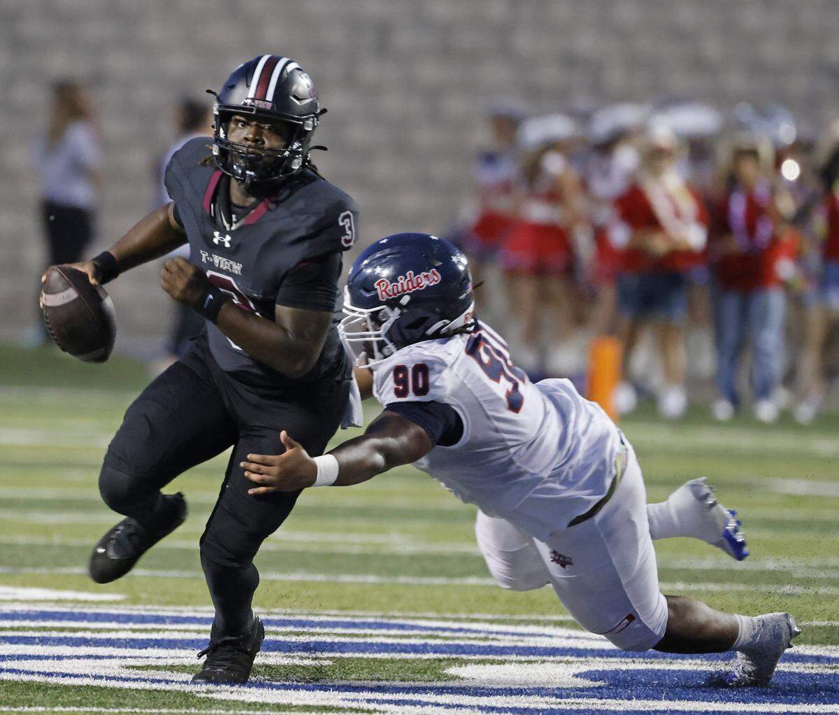 Timberview quarterback Mylez Davis (3) scrambles in the backfield defended by Ryan defensive lineman Kerri Maddox (90) during the first half of a UIL football game at Vernon Newsom Stadium in Mansfield, Texas, Thursday, Sept. 04, 2025.