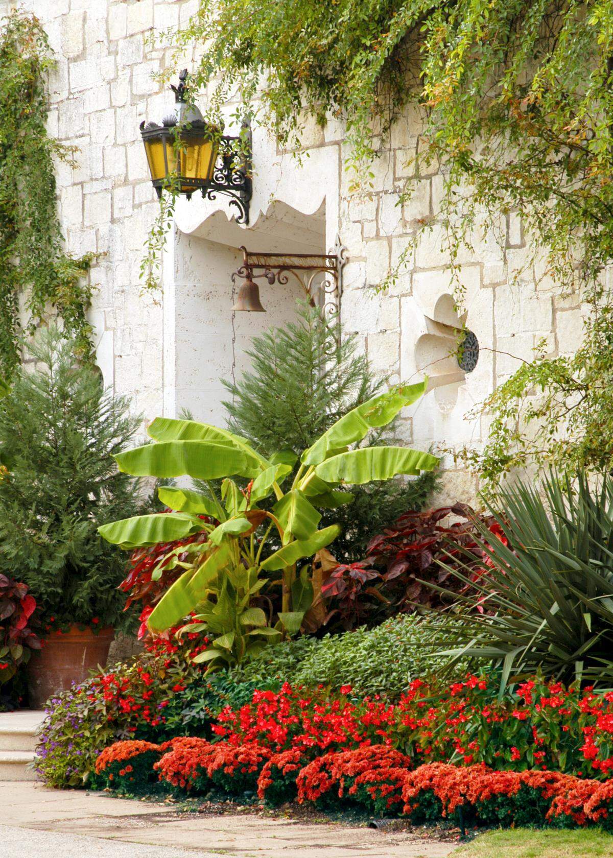 The entryway is the obvious focal point of this glamorous landscape.     