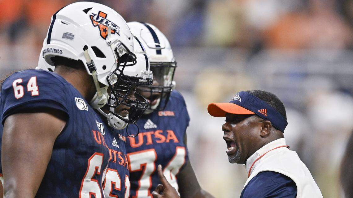UTSA head coach Frank Wilson, right, talks to players, from left to right, Josh Dunlop Kevin Davis and Spencer Burford during the first half of an NCAA college football game against Army, Saturday, Sept. 14, 2019 in San Antonio. (AP Photo/Darren Abate)