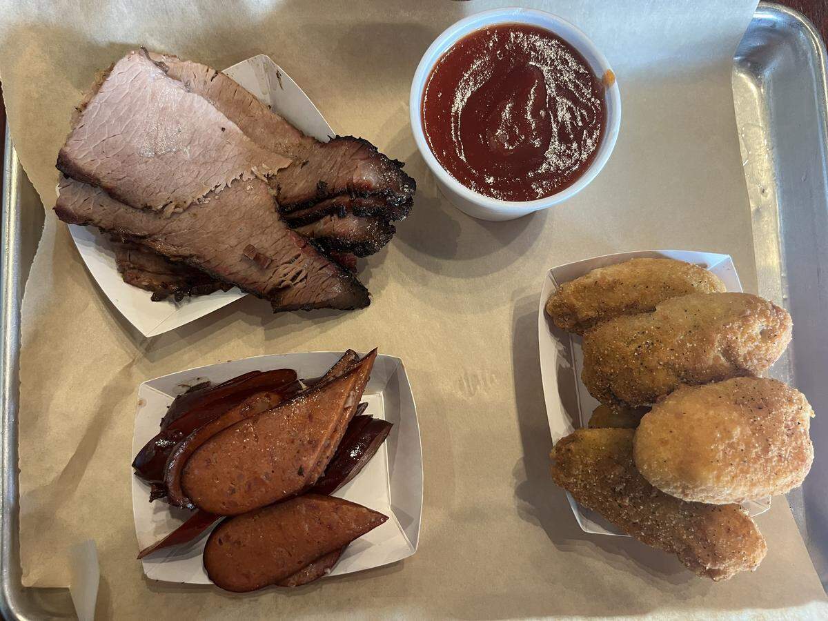 A side of brisket, a skosh of hot links and jalapeño poppers from Woody Creek Bar-B-Q in west Fort Worth at Ridgmar Mall.