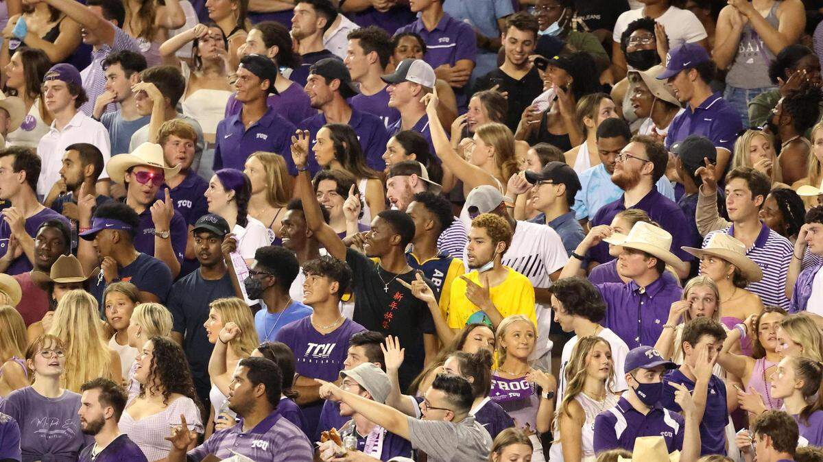 Members of the TCU student section cheer on their team as it warms up for season opener against Duquesne on Saturday night at Amon G. Carter Stadium in Fort Worth. TCU also issued approximately 70 tickets to Xavier students who have relocated to the Dallas-Fort Worth area in the aftermath of Hurricane Ida..
