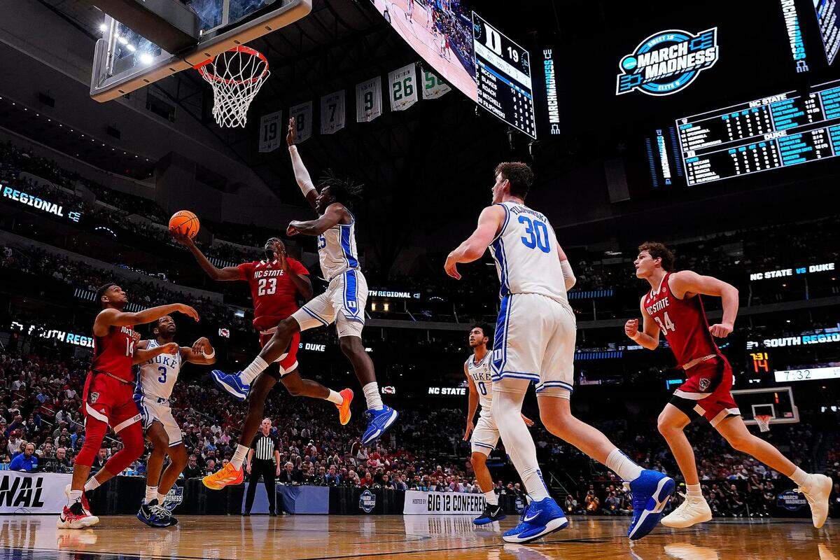 NC State forward Mohamed Diarra (23) goes for a layup over Duke forward Mark Mitchell (25) in the first half of the Elite 8 South Regional Championship game of NCAA Division I Mens Basketball Tournament at American Airlines Center in Dallas on Sunday, March 31, 2024. NC State defeated Duke 76-64.