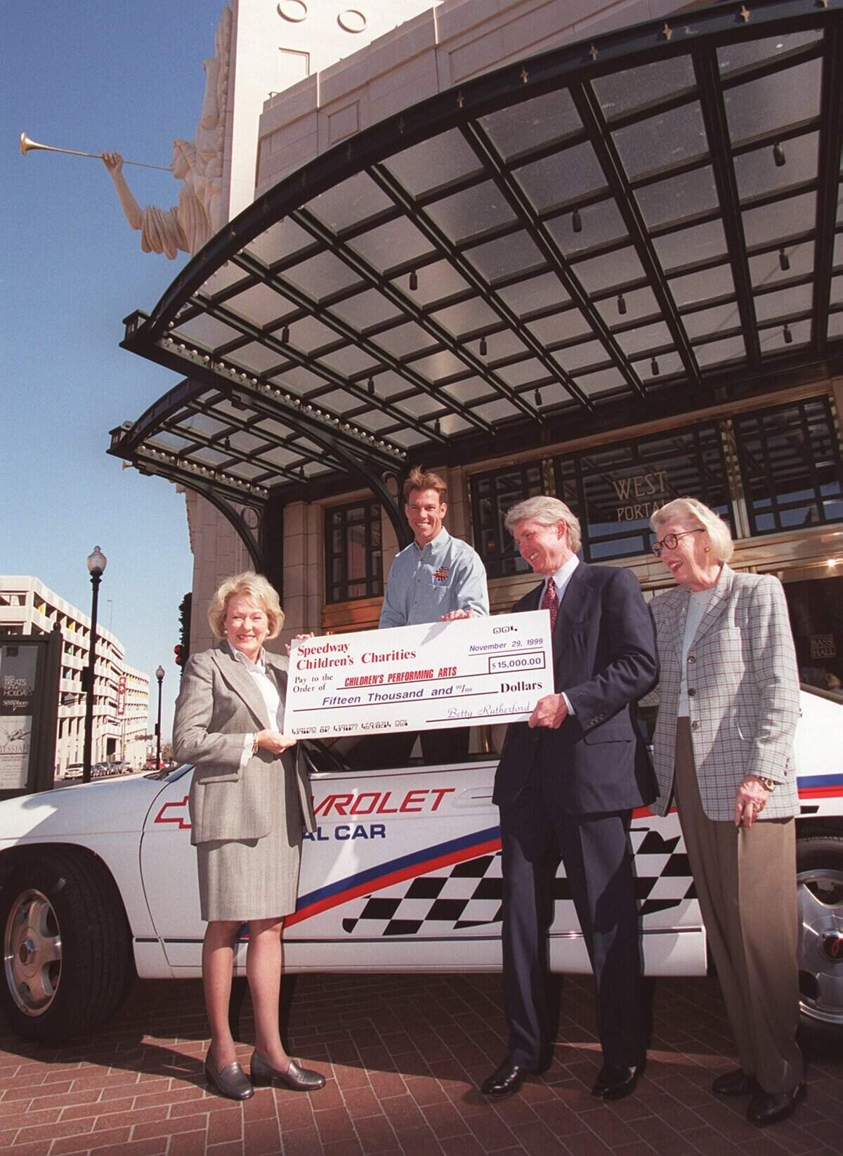 Speedway Children's Charities presents $15,000 to Performing Arts Fort Worth for children's education. Left to right are Betty Rutherford, president of the Texas chapter of Speedway Children's Charities, Greg Ray, Indy Racing League driver, Ed Bass, chairman of Performing Arts Fort Worth and Pat Schutts, Bass Performance Hall director of development. Paul Bourgeois story.