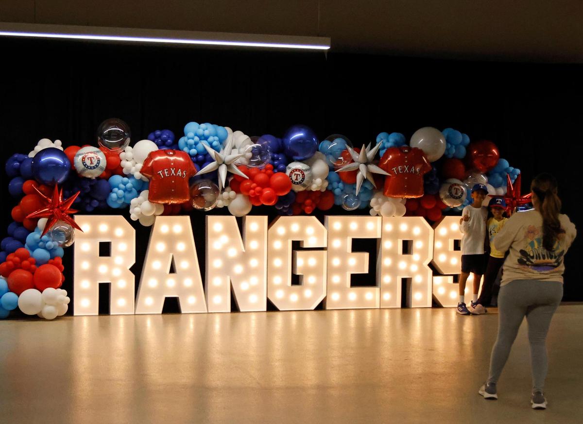 Fans pose for photos with a Rangers display during the ACLS game 7 watch party at Globe Life Field in Arlington, Texas, Friday, Oct. 23, 2023. Rangers led 4-1 in the top of the third. (Special to the Star-Telegram Bob Booth)