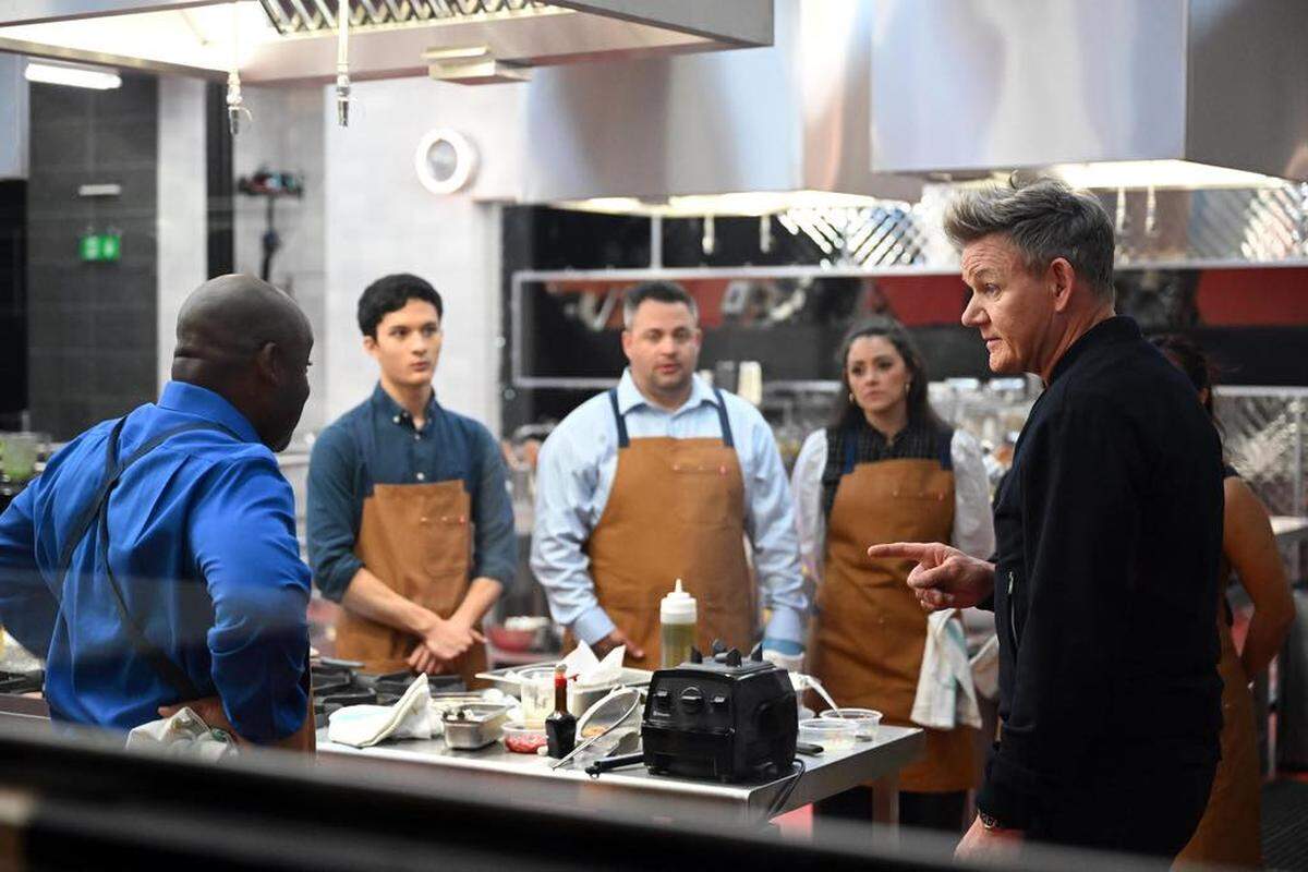 Arlington native Preston Nguyen (navy shirt) listens to celebrity chef Gordon Ramsay on set of “Next Level Chef”.