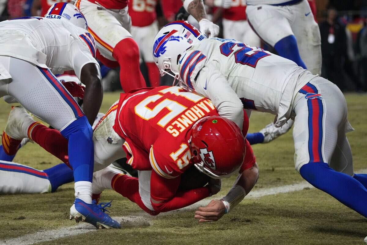 Jan 26, 2025; Kansas City, MO, USA; Kansas City Chiefs quarterback Patrick Mahomes (15) dives for a touchdown against Buffalo Bills cornerback Kaiir Elam (5) during the second half in the AFC Championship game at GEHA Field at Arrowhead Stadium. Mandatory Credit: Denny Medley-Imagn Images