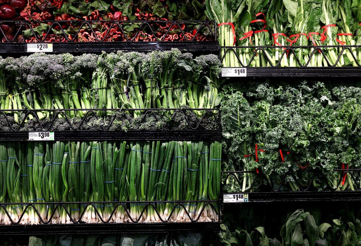 Fresh produce lines a cooler wall at the new Alliance H-E-B.