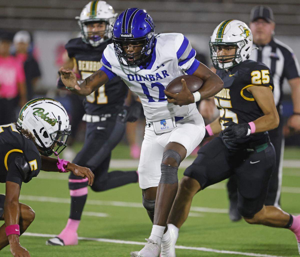 Dunbar quarterback Marcus McDade (12) takes off on a touchdown run during the first half of a UIL football game between Benbrook and Dunbar at Herman E. Clark Stadium in Fort Worth, Texas, Friday, October 10, 2025.