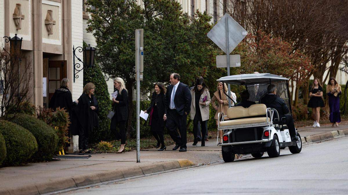 Attendees begin to make their way into the church for the Muckleroy family funeral service at University Christian Church in Fort Worth on Friday.