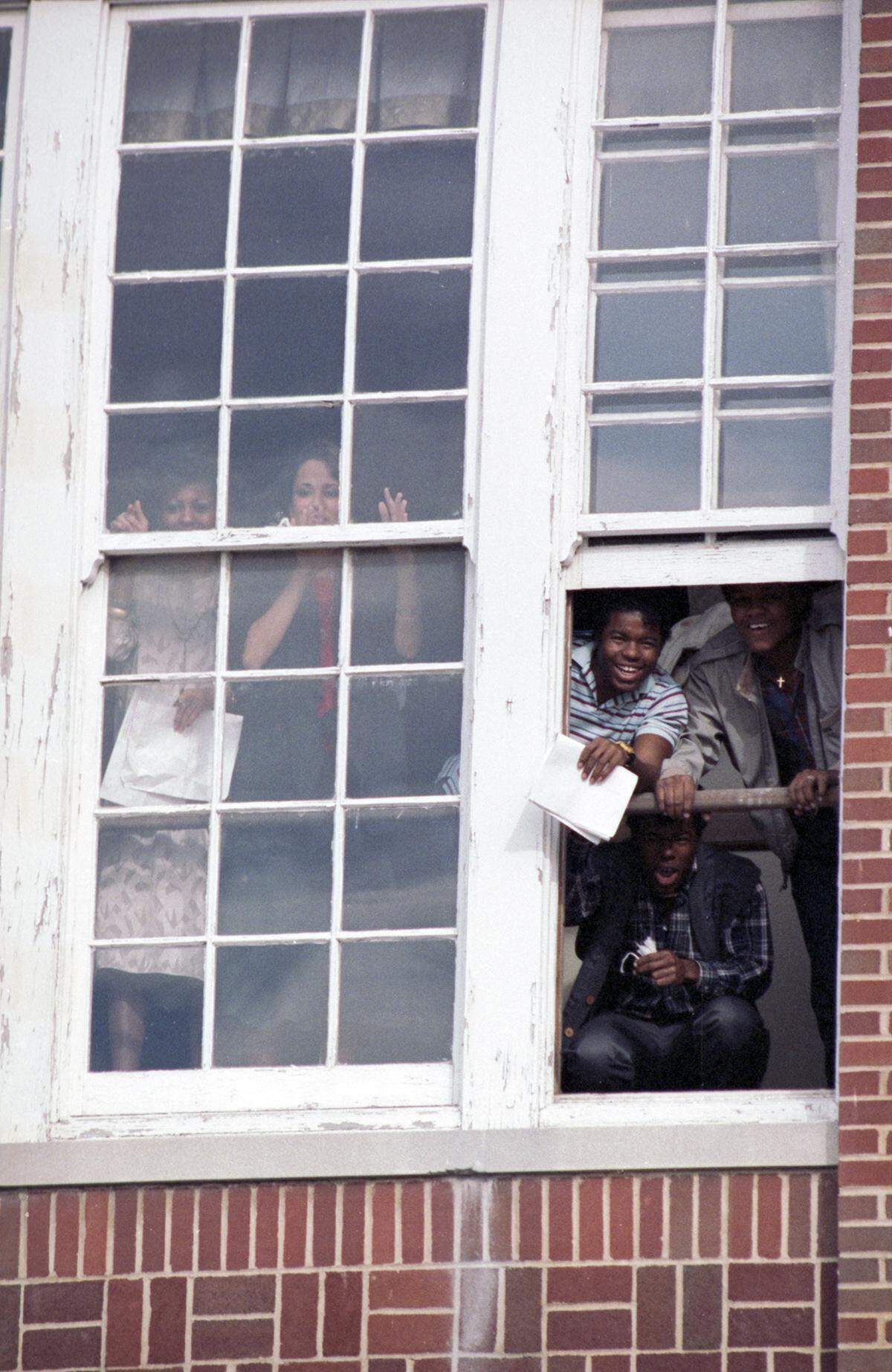 Jan. 15, 1986: Spectators look out through a window at the memorial march along East Rosedale Street in Fort Worth in honor of civil rights leader Martin Luther King, Jr.