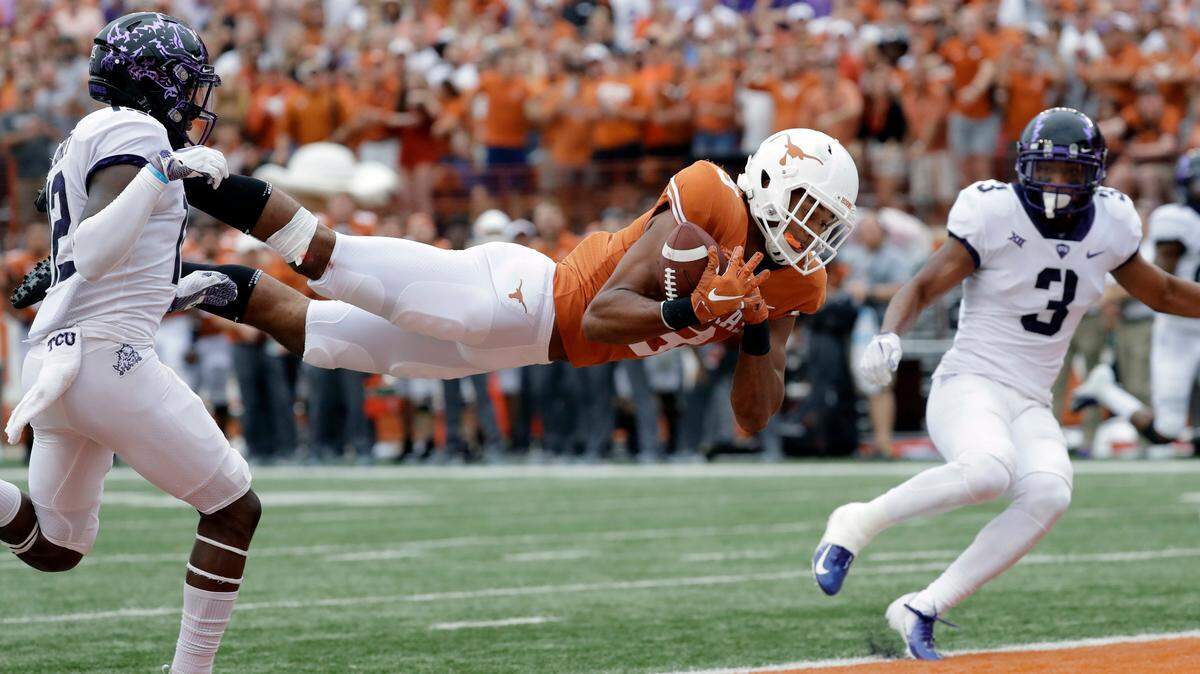 Texas wide receiver Collin Johnson (9) makes a diving catch for a touchdown between TCU defenders Jeff Gladney (12) and TCU safety Markell Simmons (3) during the second half of an NCAA college football game, Saturday, Sept. 22, 2018, in Austin, Texas. (AP Photo/Eric Gay)