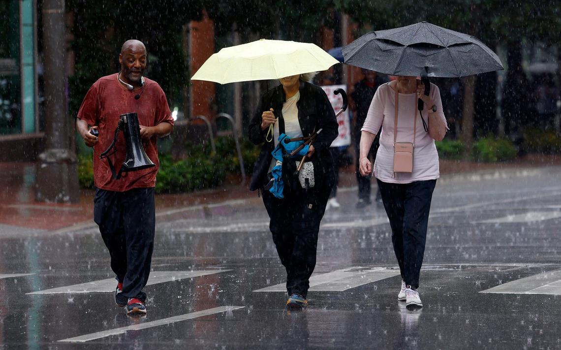 Donnell Ballard, left, and other activists march through the rain during an action to protest the deaths at the Tarrant County Jail on Thursday, May 30, 2024.