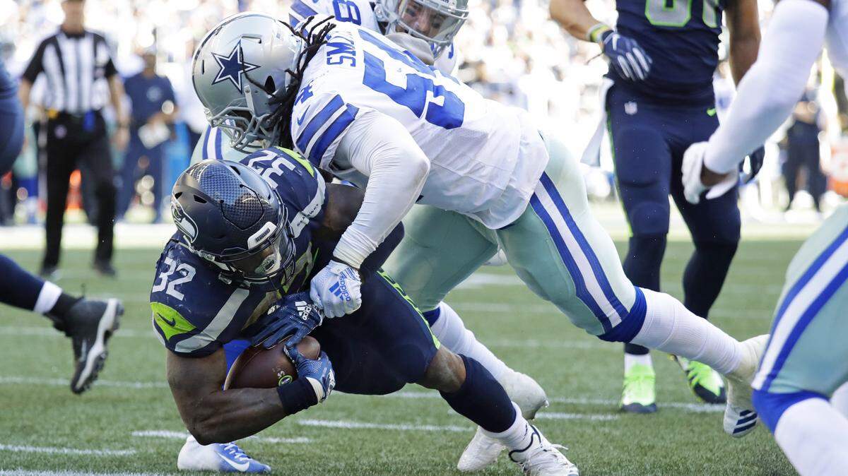 Dallas Cowboys’ linebacker Jaylon Smith tackles Seattle Seahawks’ running back Chris Carson last week at Century Link Field in Seattle.