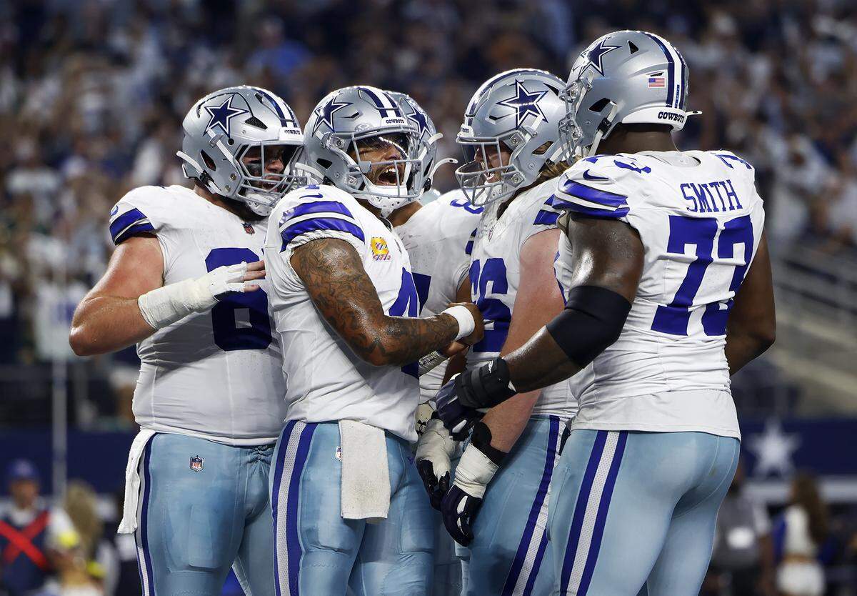 Cowboys quarterback Dak Prescott celebrates with teammates after scoring a touchdown in the second quarter against the Green Bay Packers on Sept. 28 at AT&T Stadium.