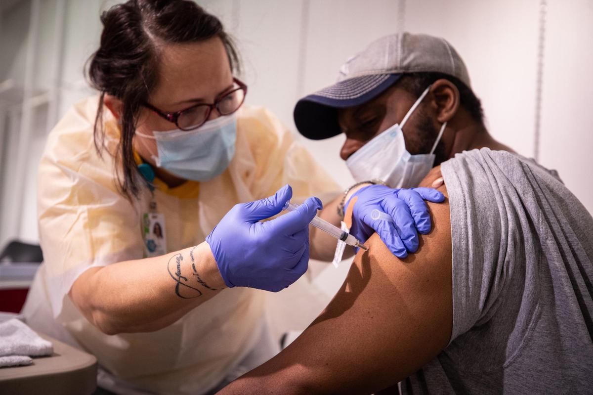 Numerous entities administered COVID-19 vaccines in Tarrant County. In this file photo, registered nurse Toni Sanson gives Demetrius Chapman a vaccination during an Immunization Collaboration of Tarrant County clinic in August 2021, at the Ridgmar Mall in Fort Worth.