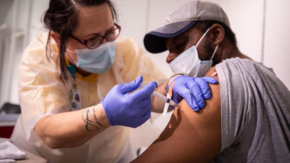 Toni Sanson, RN, gives Demetrius Chapman the COVID vaccination during an Immunization Collaboration of Tarrant County clinic in August at the Ridgmar Mall in Fort Worth. Tarrant County plans to launch a new mobile vaccination bus to help increase access to the COVID-19 vaccine.