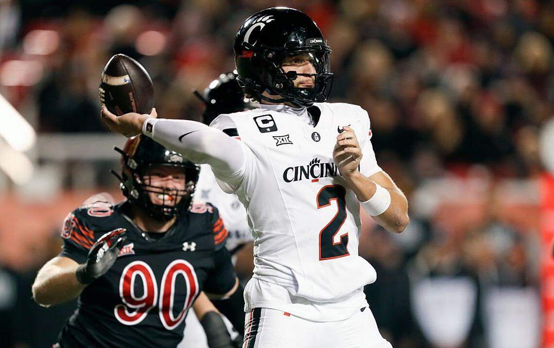 SALT LAKE CITY, UT - NOVEMBER 1: Brendan Sorsby #2 of the Cincinnati Bearcats throws a pass under pressure from John Henry Daley #90 of the Utah Utes during the second half of their game at Rice-Eccles Stadium on Nov. 1, 2025 in Salt Lake City, Utah. (Photo by Chris Gardner/Getty Images)