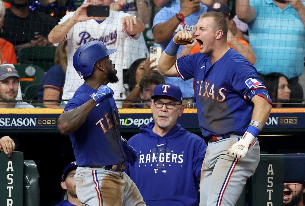 Texas Rangers right fielder Adolis Garcia (53) celebrates with third baseman Josh Jung (6) after hitting a home run during the third inning of game seven in the ALCS against the Houston Astros for the 2023 MLB playoffs at Minute Maid Park.