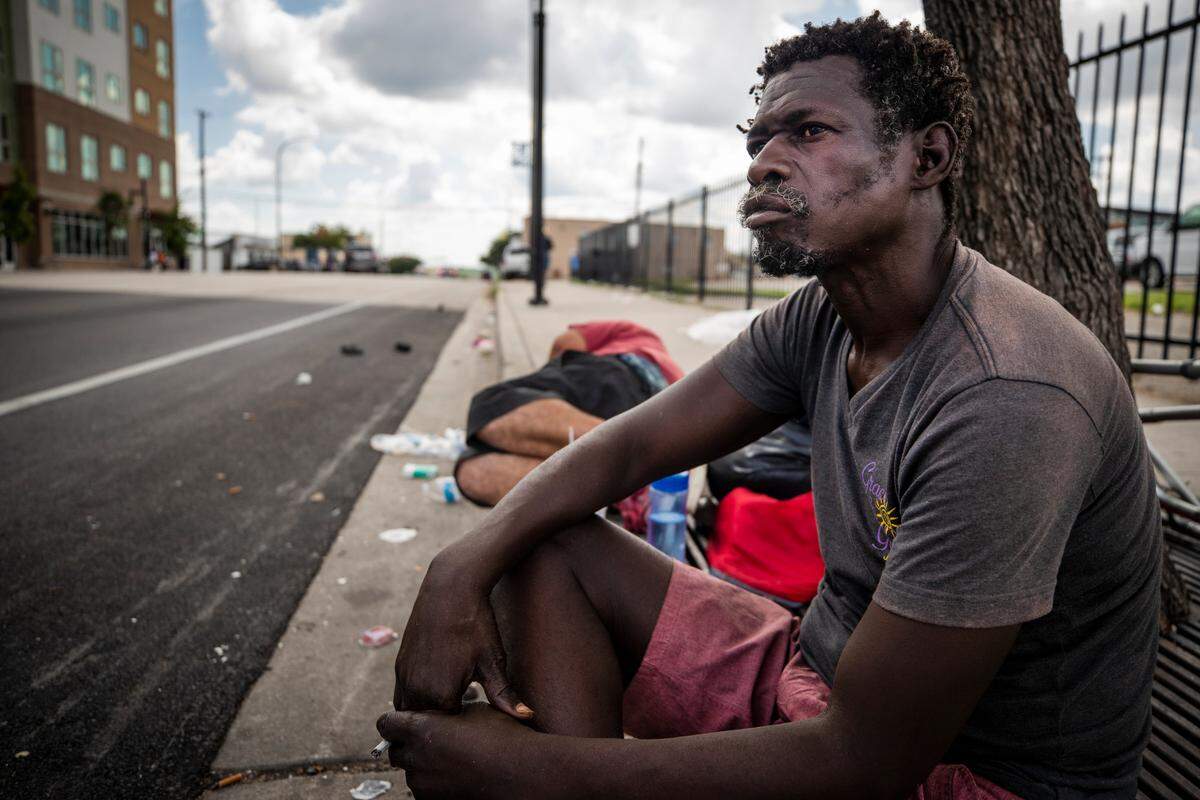 Rodney Austin, who is experiencing homelessness, sits along Lancaster Avenue Thursday in Fort Worth. Officials in Fort Worth say they plan to focus on finding housing for the homeless as a ban on camping in public spaces takes effect Sept. 1.