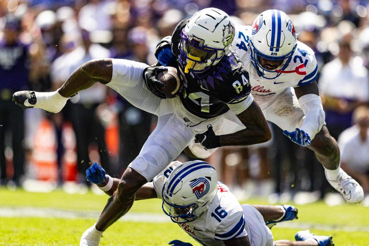 TCU wide receiver Warren Thompson (84) catches a pass between two SMU defenders in the second half of a BIG 12 football game between the TCU Horned Frogs and the SMU Mustangs at Amon G. Carter Stadium in Fort Worth on Saturday, Sept. 23, 2023.