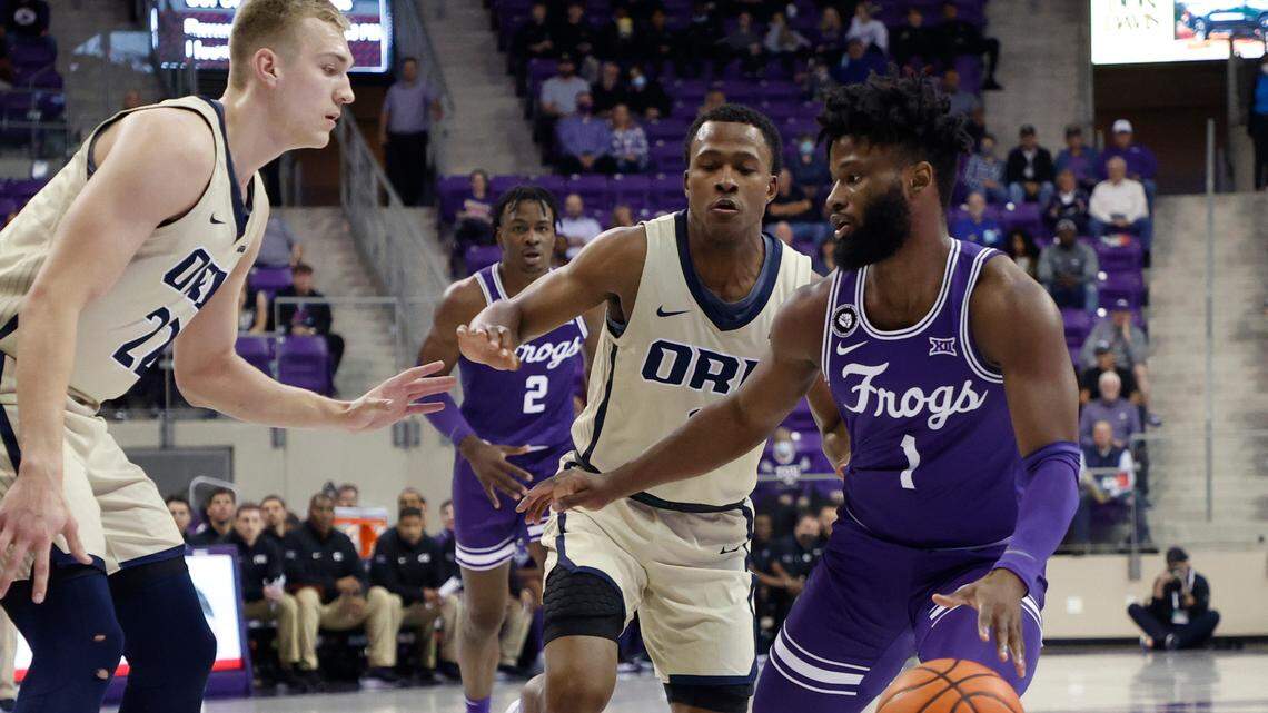 TCU’s Mike Miles, right, works against Oral Roberts’ defense in the first half of Thursday night’s game at Schollmaier Arena in Fort Worth. Miles finished with 13 points in the Horned Frogs’ 71-63 victory.