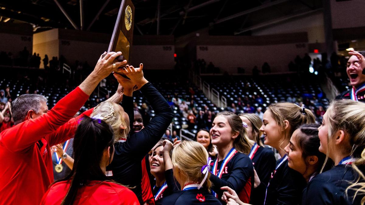 The Panthers rush the trophy after Colleyville Heritage beat Frisco Reedy in the 5A state final at the Curtis Culwell Center in Garland on November 19th, 2022.