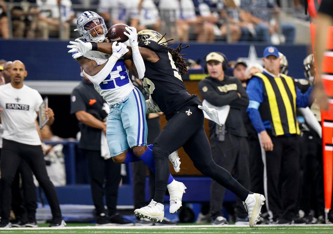 Dallas Cowboys running back Rico Dowdle attempts to make a catch while defended by New Orleans Saints linebacker Demario Davis on Sunday, Sept. 15, 2024, at AT&T Stadium in Arlington.