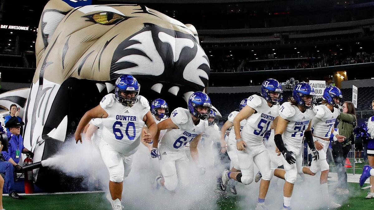 The Gunter Tigers enter the field for the first half of a conference 3A division II State Championship football game at AT&T in Arlington, Texas, Thursday, Dec. 19, 2019. The game was tied at 22 at the half. (Special to the Star-Telegram Bob Booth)