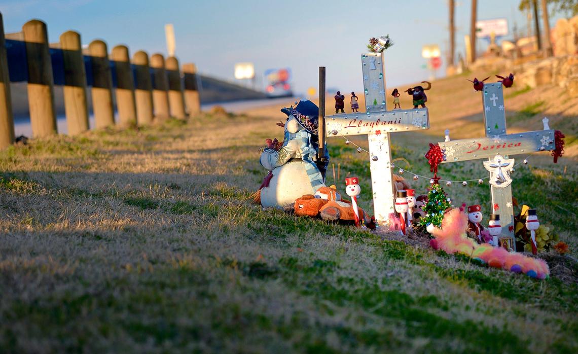 Two crosses, one marked Llaylanii and the other marked Jessica, are adorned with stuffed animals and Christmas decorations at a culvert along a service road to East Loop 820 South in Fort Worth where Jessica Romero, 18, and her 2-year-old daughter Llaylanii died. Their car was swept off the road by flood waters.