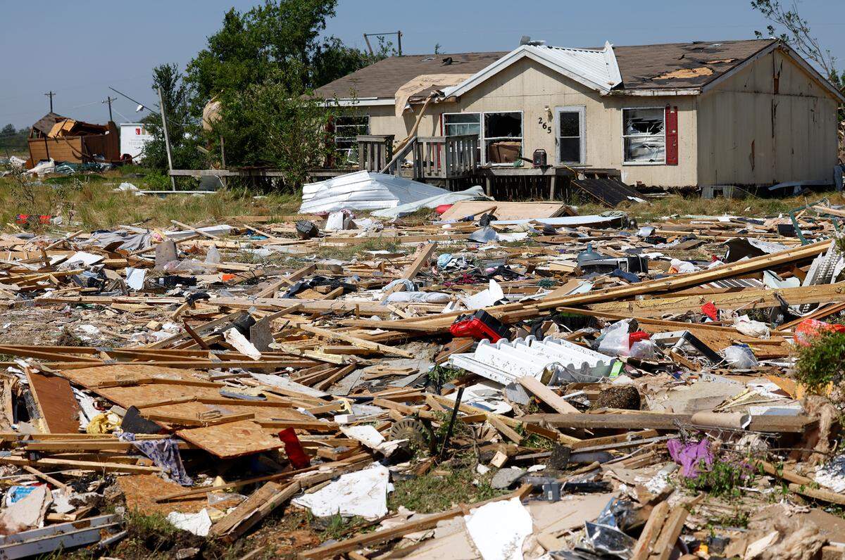 Debris surrounds a home in Valley View on Sunday, May 26, 2024, after severe storms moved through Denton and Cooke counties.