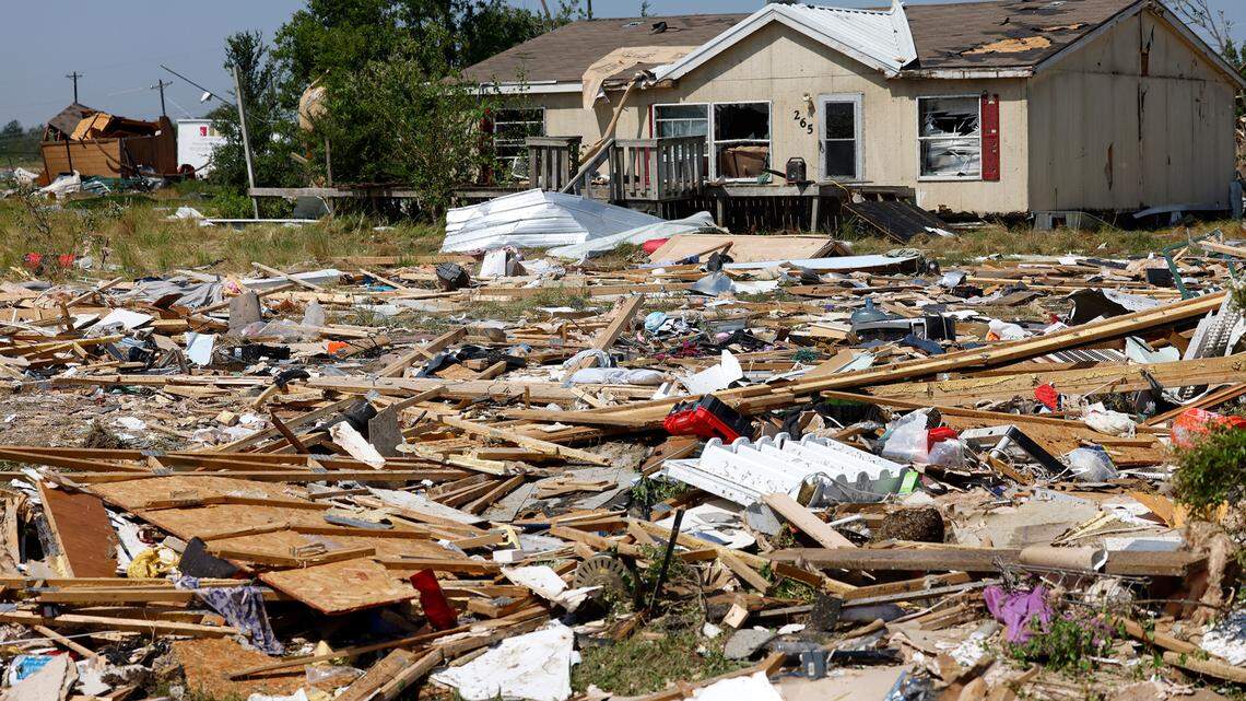 Debris surrounds a home in Valley View on Sunday after a tornado moved through Denton and Cooke counties. Seven people died in the storm.