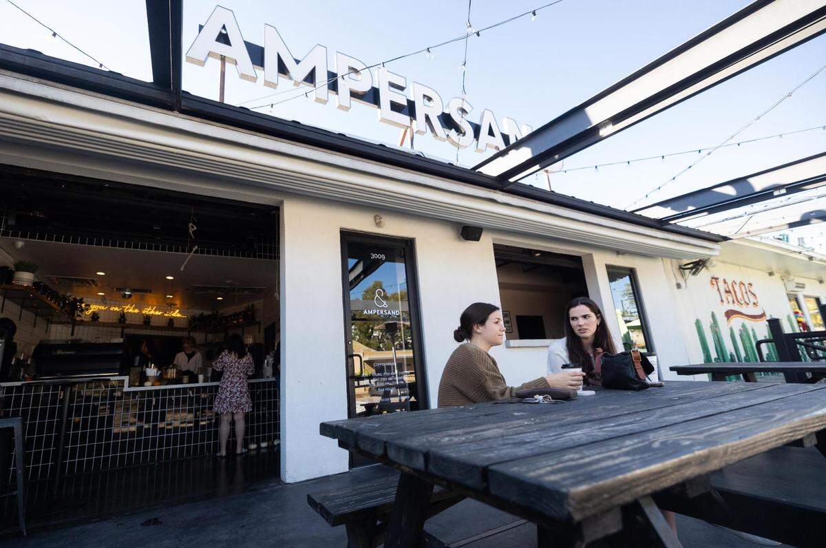 Meredith Thomas, left, and Mairin Hasson drink coffee outside at Ampersand on Friday, Oct. 21, 2022, in Fort Worth. Ampersand topped the poll for Star-Telegram Readers’ Choice: Best Coffee Shop.