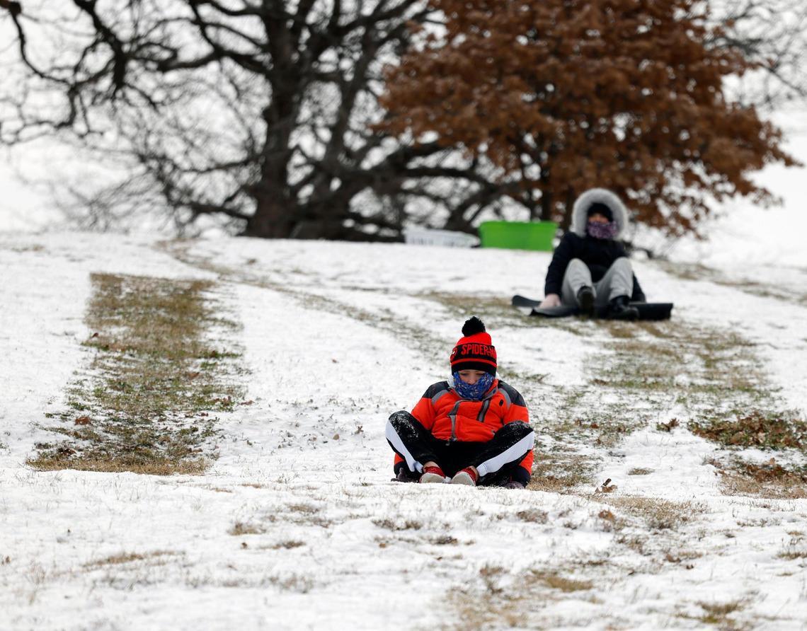 Bryson, 8 and Addy, 11, slide down a hill at Bedford Boys Ranch during the areas first freeze of the season in Bedford, Texas, Monday, Jan, 15, 2024. Temperature during the early morning was 9 with a wind chill of -7. (Special to the Star-Telegram Bob Booth)