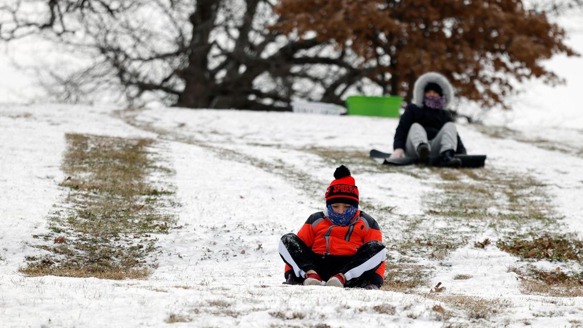 Bryson, 8 and Addy, 11, slide down a hill at Bedford Boys Ranch during the areas first freeze of the season in Bedford, Texas, Monday, Jan, 15, 2024. Temperature during the early morning was 9 with a wind chill of -7. (Special to the Star-Telegram Bob Booth)