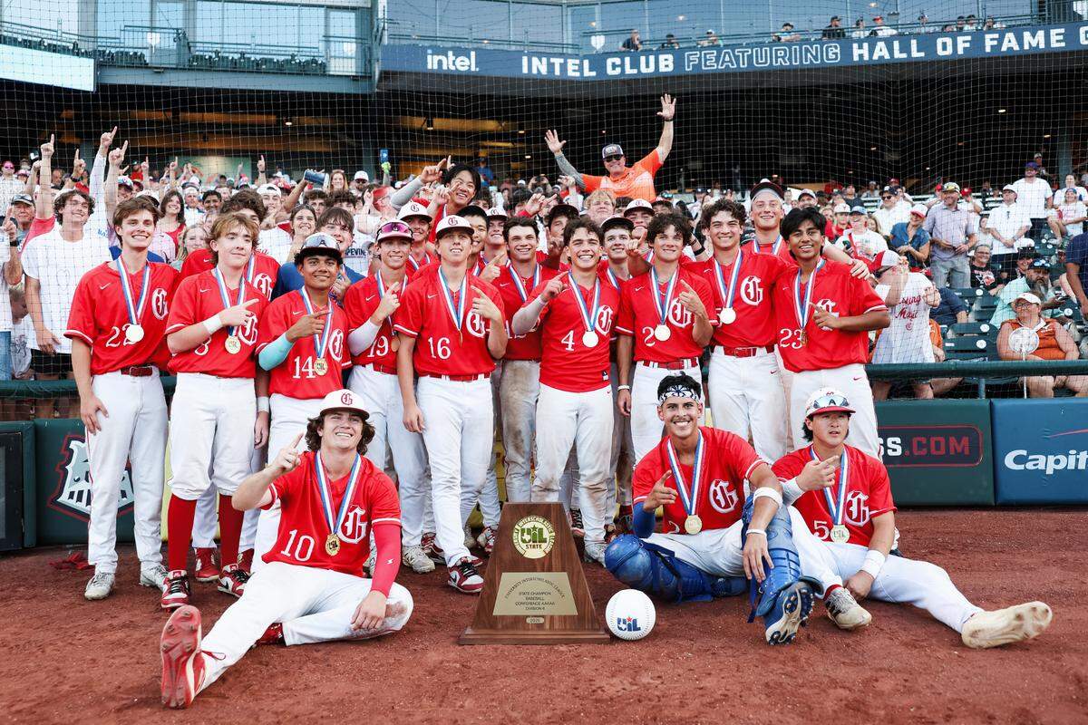 Grapevine players stand in front of the Grapevine fans with the championship trophy after defeating Kingwood Park 9-5 in the Class 5A Division II state championship game on Friday, June 6, 2025 at Dell Diamond in Round Rock, Texas.